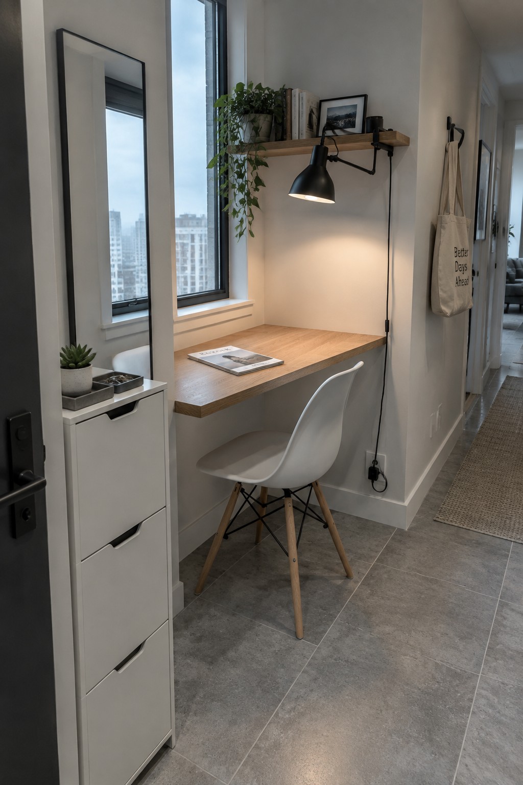 Modern wooden desk nook with white chair, black lamp, floating shelf and city window