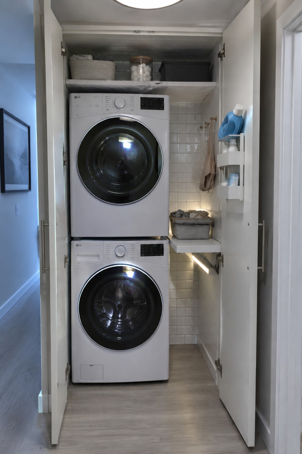 Stacked white LG washer and dryer inside an open white closet with a round flush mount ceiling light visible at the top.