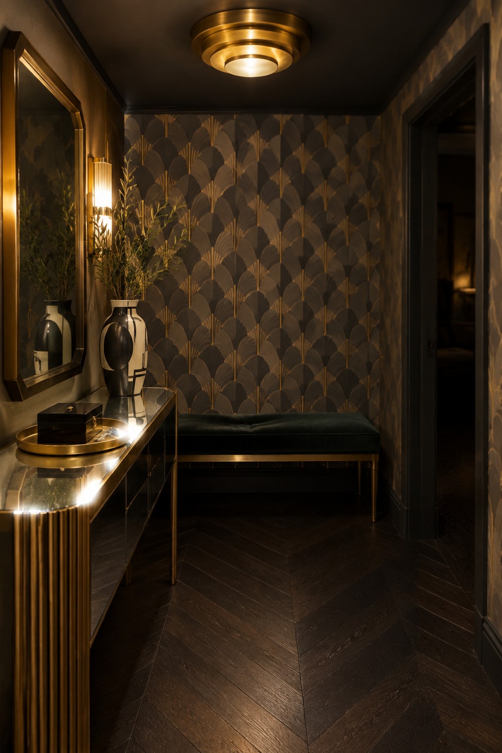 Art Deco hallway with fan-patterned wallpaper, green velvet bench, and gold console.